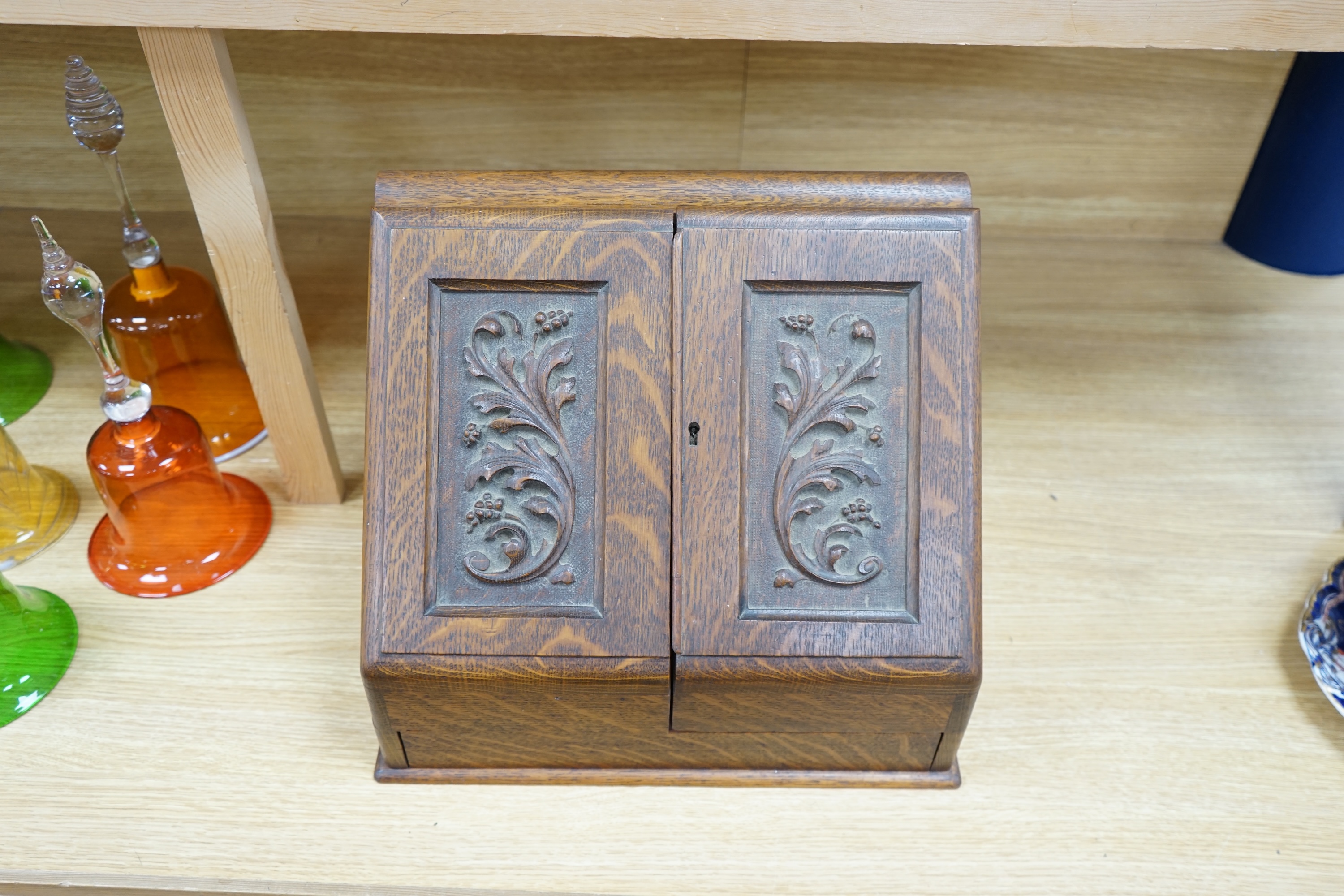 A Victorian carved oak stationery box, 33cm tall. Condition - good